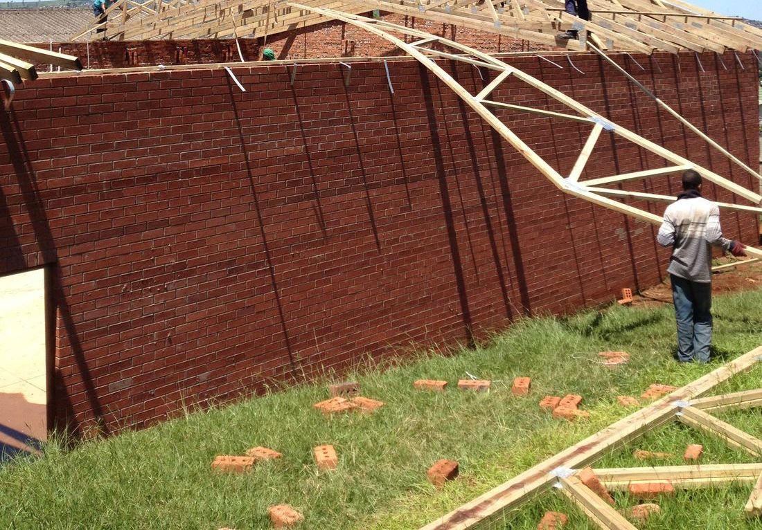 Builders fitting the roof trusses on the new hall